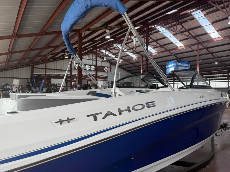 Slide: The Image of 2022 Tahoe 200S boat displayed in a warehouse. - 2