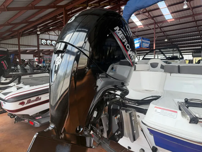 Slide: The Image of 2022 Tahoe 200S with Mercury outboard motor in a boat workshop. - 3