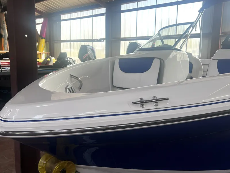 Slide: The Image of 2022 Tahoe 200S boat displayed indoors. - 4