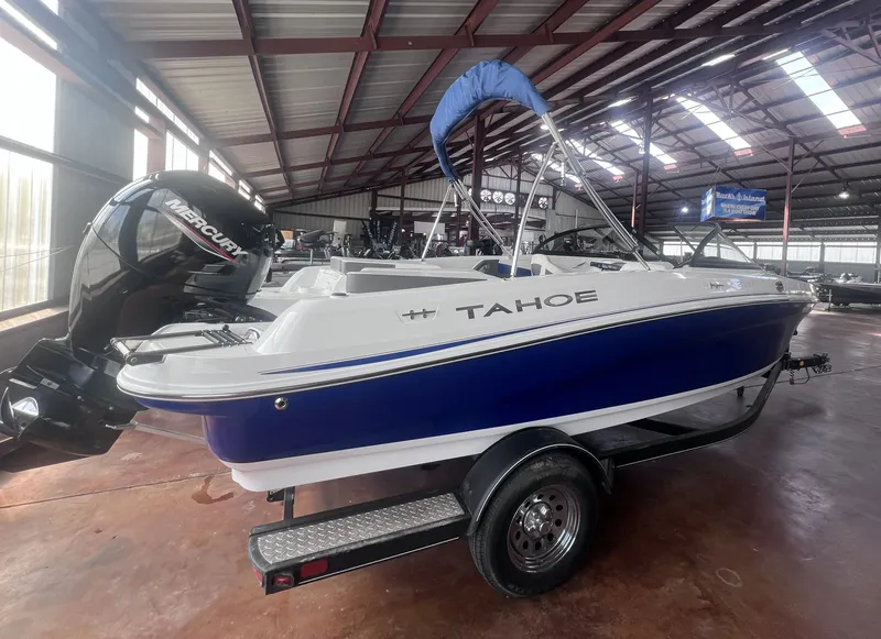 Slide: The Image of 2022 Tahoe 200S boat displayed in a warehouse. - 6
