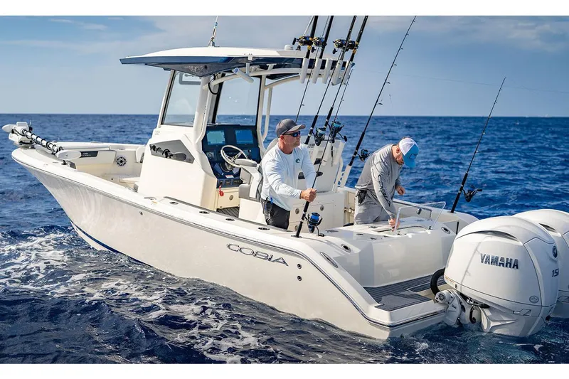 Slide: The Image of Manufacturer Provided Image: 2026 Cobia 245 Center Console boat with anglers fishing in open ocean. - 4