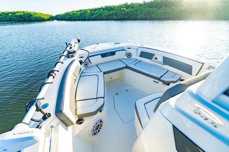 Slide: The Image of Manufacturer Provided Image: 2026 Cobia 245 Center Console boat interior on calm water, featuring spacious seating. - 6