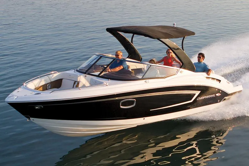 The Image of 2014 Chaparral 257 SSX boat on trailer, black and white design, parked outdoors. - 0