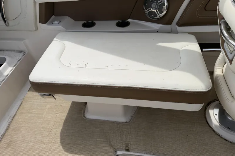 Slide: The Image of 2014 Chaparral 257 SSX boat interior seating with white and brown upholstery. - 14