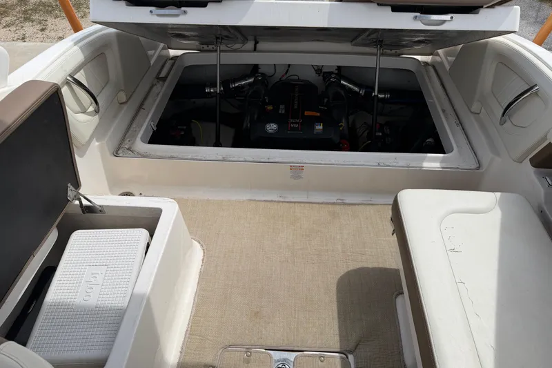 Slide: The Image of 2014 Chaparral 257 SSX boat interior with open engine compartment and seating area. - 15