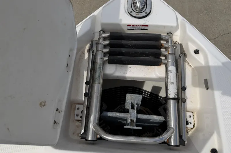 Slide: The Image of Anchor compartment of a 2014 Chaparral 257 SSX boat with ladder and anchor. - 16