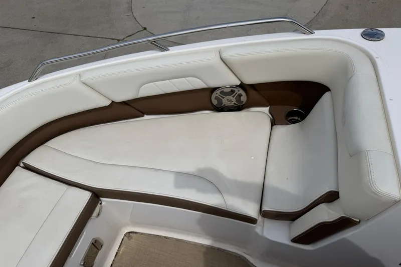 Slide: The Image of 2014 Chaparral 257 SSX boat interior with white and brown seating. - 19