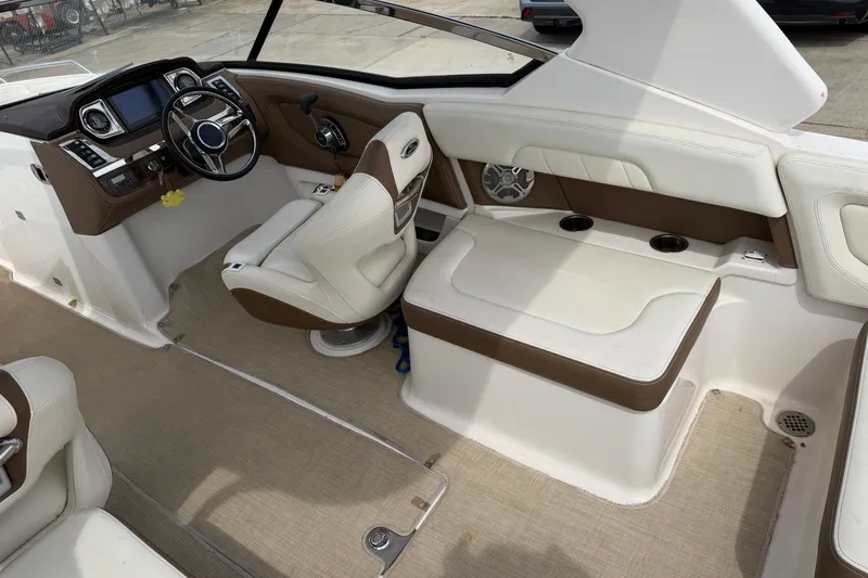 Slide: The Image of 2014 Chaparral 257 SSX boat interior with steering wheel and seating area. - 26