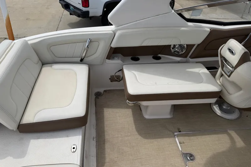 Slide: The Image of 2014 Chaparral 257 SSX boat interior with white and brown seating. - 29