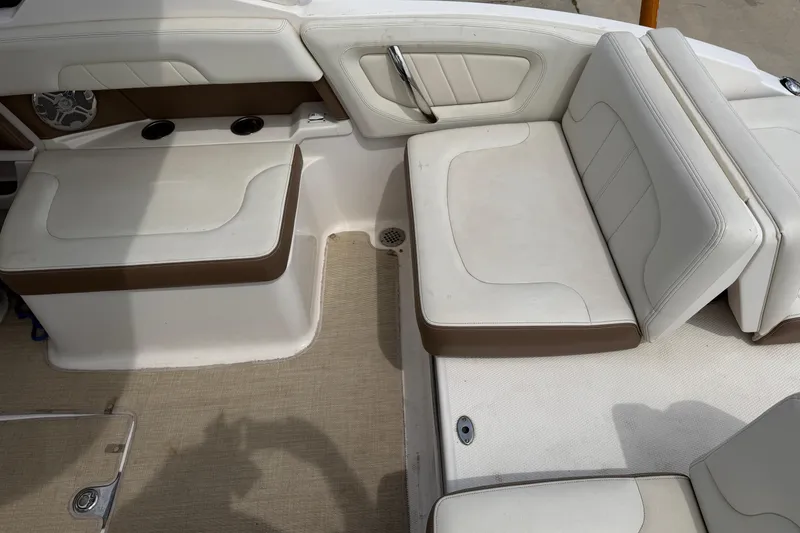 Slide: The Image of 2014 Chaparral 257 SSX boat interior with white and brown seating. - 30