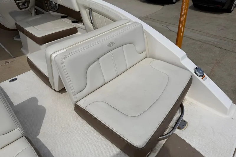 Slide: The Image of 2014 Chaparral 257 SSX boat interior with white and brown seating. - 34