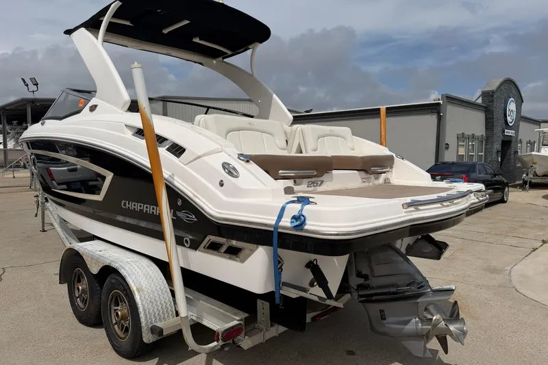 Slide: The Image of 2014 Chaparral 257 SSX boat on trailer, parked outdoors near a building. - 36
