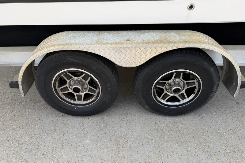 Slide: The Image of Trailer wheels of a 2014 Chaparral 257 SSX boat on a concrete surface. - 37