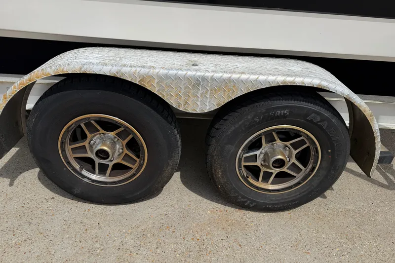 Slide: The Image of Trailer wheels of a 2014 Chaparral 257 SSX boat on a concrete surface. - 38