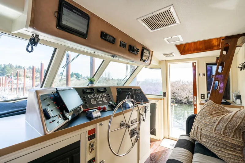 Slide: The Image of Interior helm of 1986 Hatteras 63 Motor Yacht with steering wheel and navigation equipment. - 10