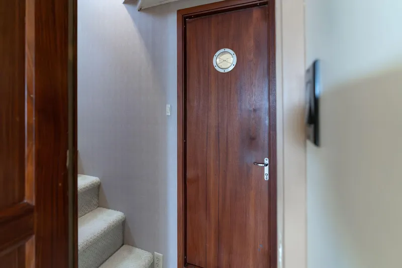 Slide: The Image of Wooden door with porthole on 1986 Hatteras 63 Motor Yacht interior. - 107