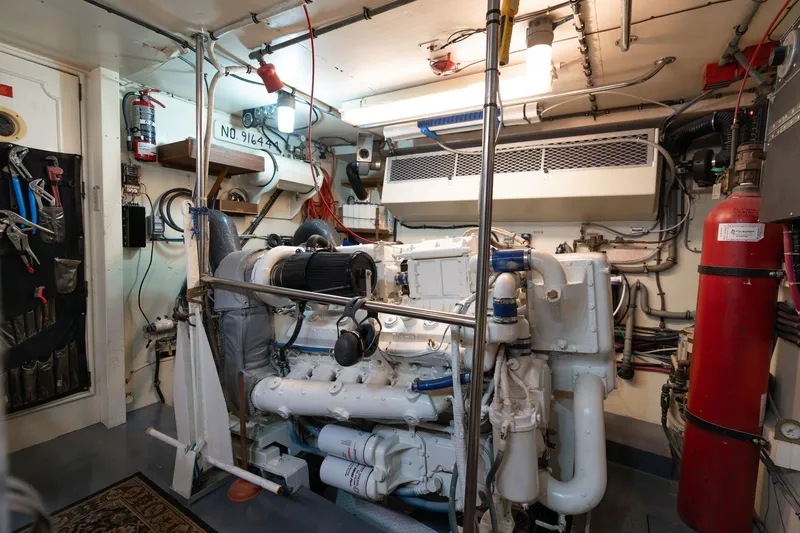 Slide: The Image of Engine room of 1986 Hatteras 63 Motor Yacht, featuring machinery and tools. - 108