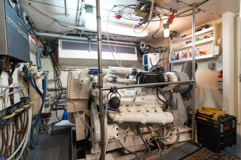 Slide: The Image of Engine room of a 1986 Hatteras 63 Motor Yacht, showcasing machinery and equipment. - 109