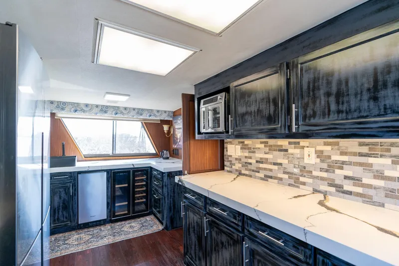 Slide: The Image of Interior of 1986 Hatteras 63 Motor Yacht kitchen with modern cabinetry and appliances. - 11