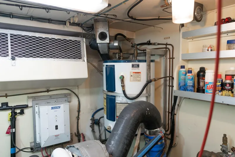 Slide: The Image of Engine room of 1986 Hatteras 63 Motor Yacht with equipment and maintenance supplies. - 112