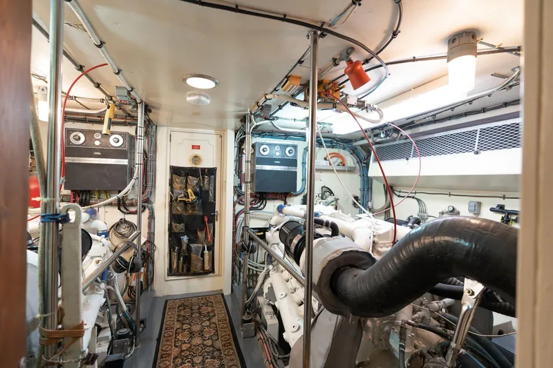 Slide: The Image of Engine room of a 1986 Hatteras 63 Motor Yacht, showcasing machinery and equipment. - 116