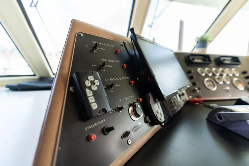 Slide: The Image of Control panel of a 1986 Hatteras 63 Motor Yacht, featuring switches and gauges. - 119