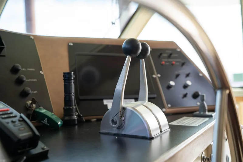 Slide: The Image of Control panel of a 1986 Hatteras 63 Motor Yacht with throttle levers and navigation equipment. - 121