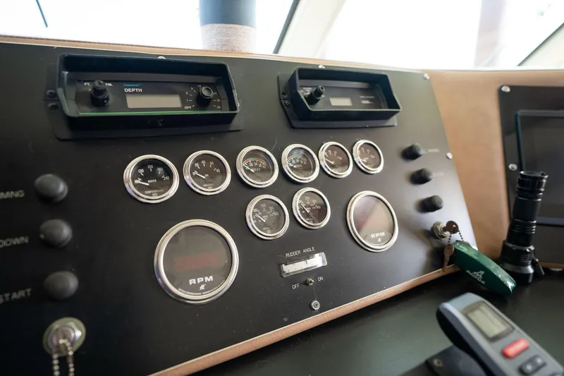 Slide: The Image of Control panel of a 1986 Hatteras 63 Motor Yacht with gauges and switches. - 122