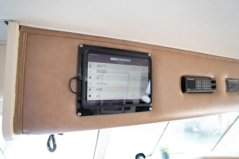 Slide: The Image of Control panel on 1986 Hatteras 63 Motor Yacht displaying weather data. - 123