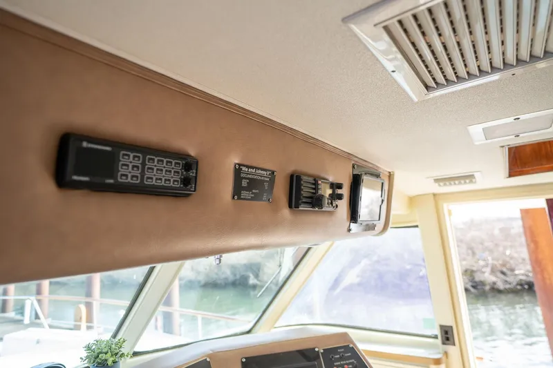 Slide: The Image of Interior view of 1986 Hatteras 63 Motor Yacht helm with control panel and equipment. - 124