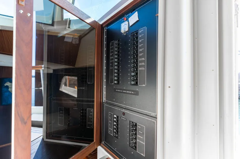 Slide: The Image of Electrical panel inside 1986 Hatteras 63 Motor Yacht, showcasing circuit breakers and controls. - 126