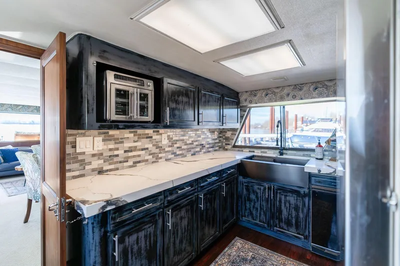 Slide: The Image of Luxurious kitchen interior of a 1986 Hatteras 63 Motor Yacht with modern appliances. - 13