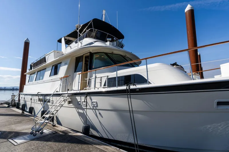 Slide: The Image of 1986 Hatteras 63 Motor Yacht docked under clear blue sky. - 130
