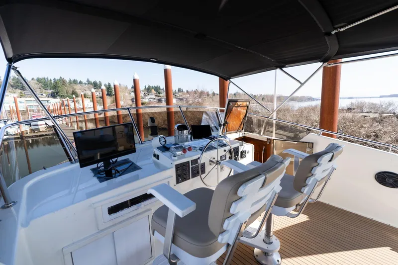 Slide: The Image of 1986 Hatteras 63 Motor Yacht helm with dual seats and navigation equipment. - 131