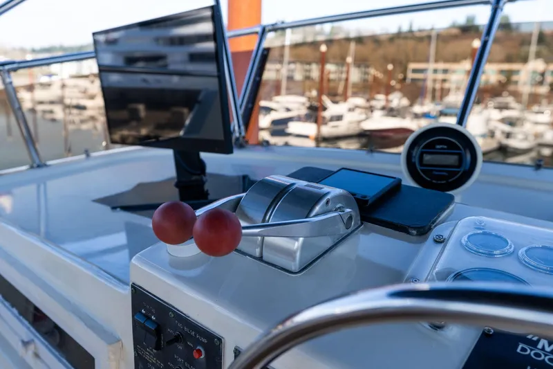 Slide: The Image of Control panel of a 1986 Hatteras 63 Motor Yacht with marina view. - 135