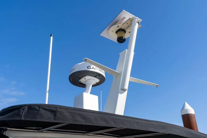 Slide: The Image of Radar and antenna equipment on a 1986 Hatteras 63 Motor Yacht against a clear blue sky. - 138