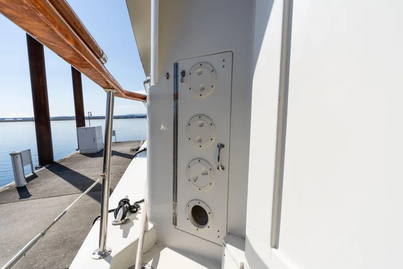 Slide: The Image of 1986 Hatteras 63 Motor Yacht deck with utility panel and railing, dockside view. - 139