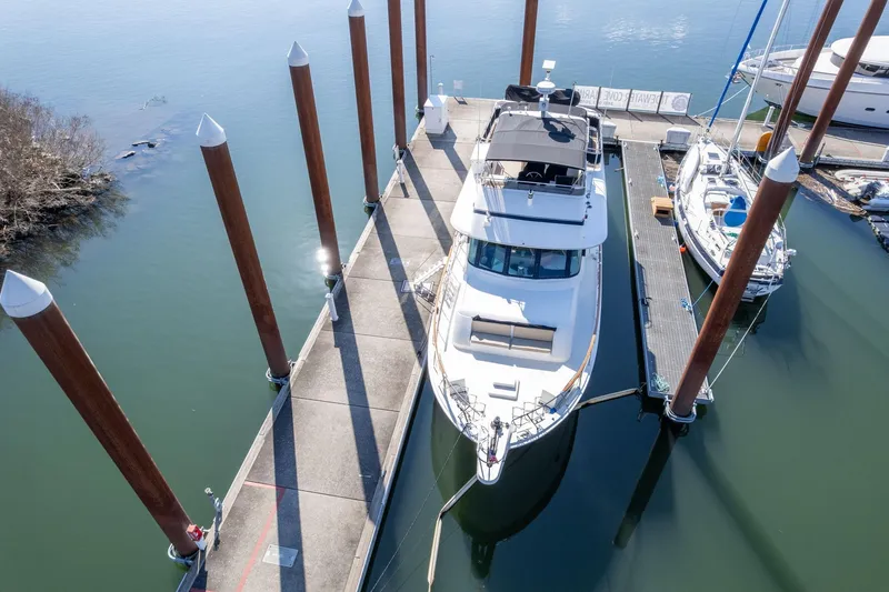 Slide: The Image of 1986 Hatteras 63 Motor Yacht docked at marina, aerial view. - 140