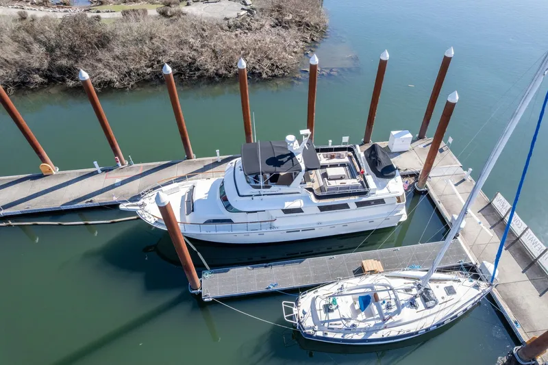 Slide: The Image of 1986 Hatteras 63 Motor Yacht docked at marina, aerial view. - 141