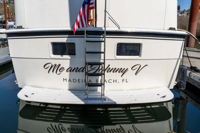 Slide: The Image of Stern view of 1986 Hatteras 63 Motor Yacht, "Me and Johnny V," docked in Madeira Beach, FL. - 148