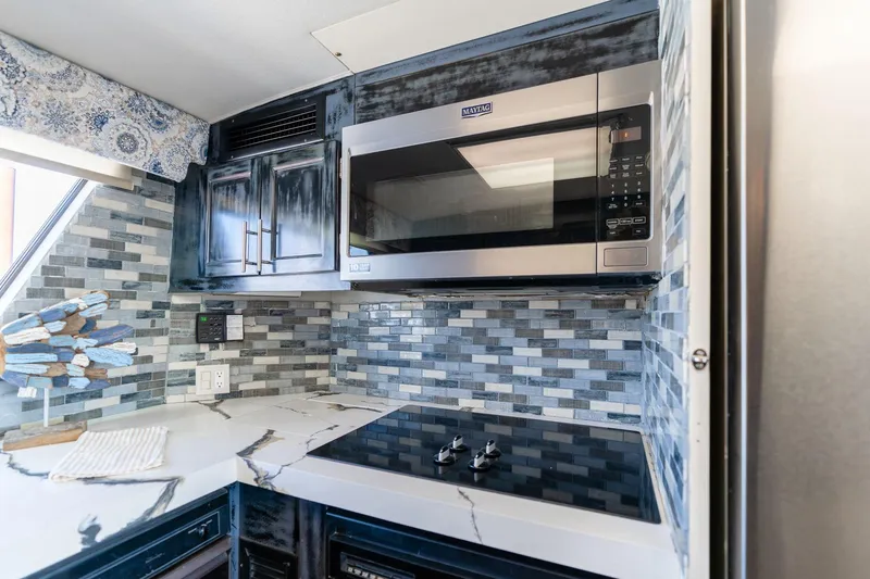 Slide: The Image of Modern kitchen in 1986 Hatteras 63 Motor Yacht with sleek appliances and stylish backsplash. - 15