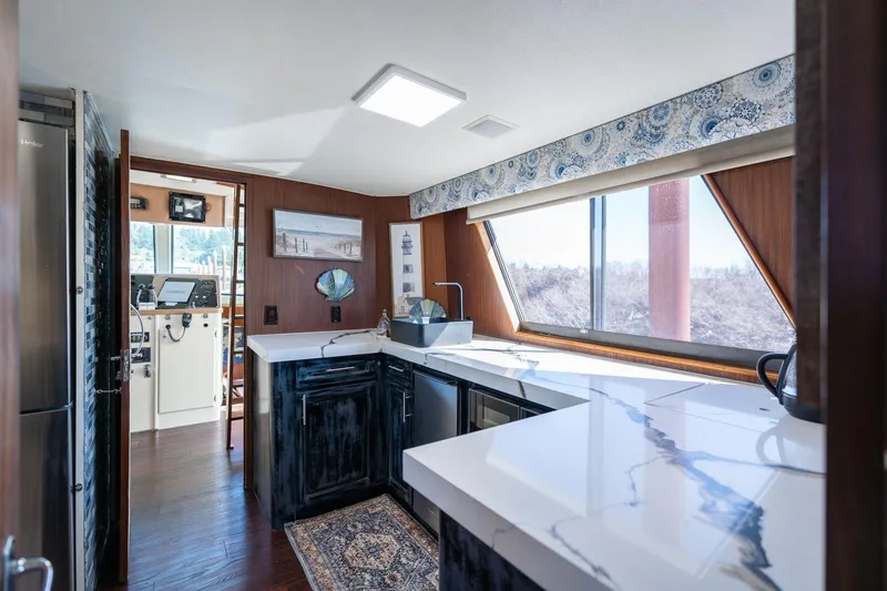 Slide: The Image of Interior of 1986 Hatteras 63 Motor Yacht with modern kitchen and panoramic windows. - 16