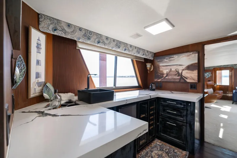 Slide: The Image of Luxurious kitchen interior of a 1986 Hatteras 63 Motor Yacht with modern countertops and nautical decor. - 18