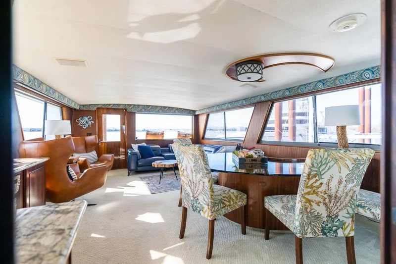 Slide: The Image of Luxurious interior of a 1986 Hatteras 63 Motor Yacht with elegant seating and decor. - 21