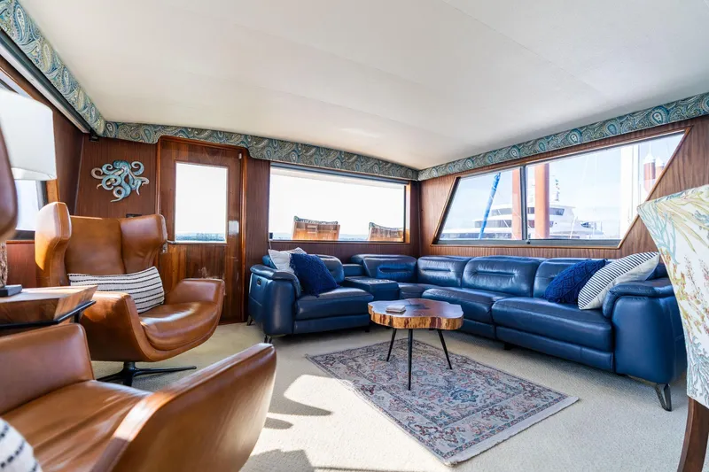 Slide: The Image of Luxurious interior of 1986 Hatteras 63 Motor Yacht with blue leather seating and elegant decor. - 22