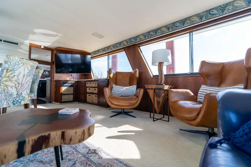 Slide: The Image of Luxurious interior of 1986 Hatteras 63 Motor Yacht with leather chairs and modern decor. - 24