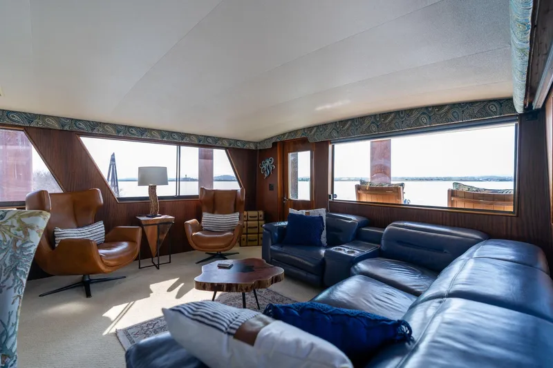 Slide: The Image of Luxurious interior of 1986 Hatteras 63 Motor Yacht with leather seating and panoramic windows. - 25