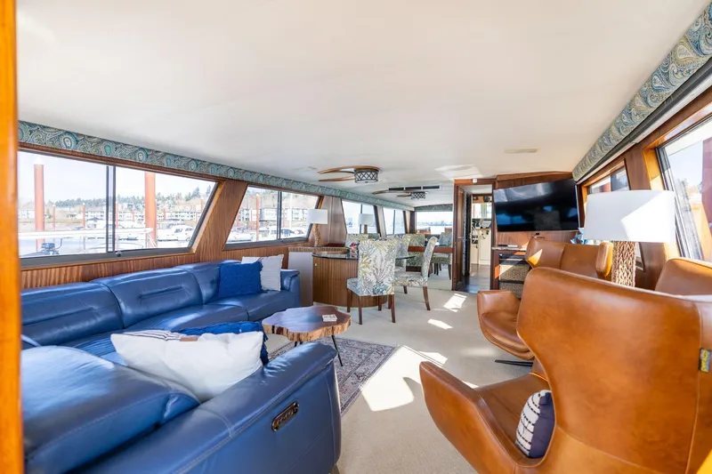 Slide: The Image of Luxurious interior of 1986 Hatteras 63 Motor Yacht with leather seating and large windows. - 26