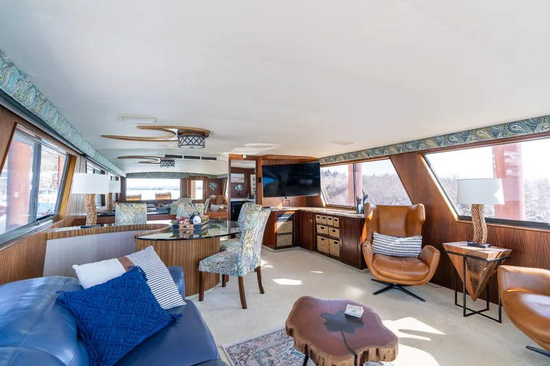 Slide: The Image of Luxurious interior of 1986 Hatteras 63 Motor Yacht with elegant furnishings and panoramic windows. - 27