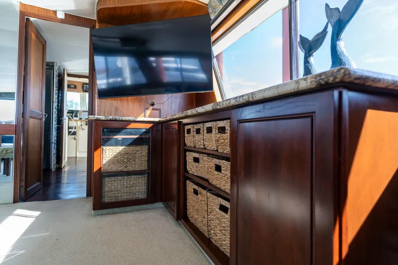Slide: The Image of Luxurious interior of 1986 Hatteras 63 Motor Yacht with elegant wood cabinetry and modern TV. - 28